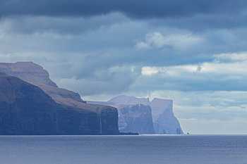 View of the rocks of the Faroe Islands with clouds