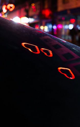 Night over St. Pauli: Reflected neon hearts by Nils Steiner