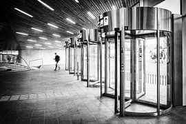 Revolving doors in Arnhem central station in black and white by Bart Ros