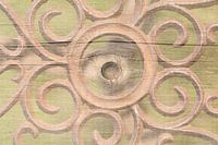 Metal with round shapes on wood in soft colours