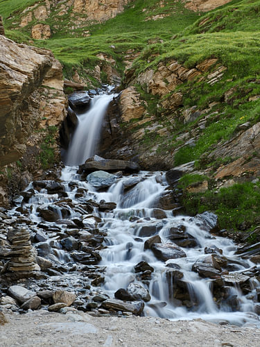 Mountain stream with cairns