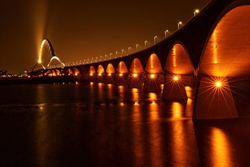 Bridge De Oversteek in Nijmegen in warm evening light by Marjo Snellenburg