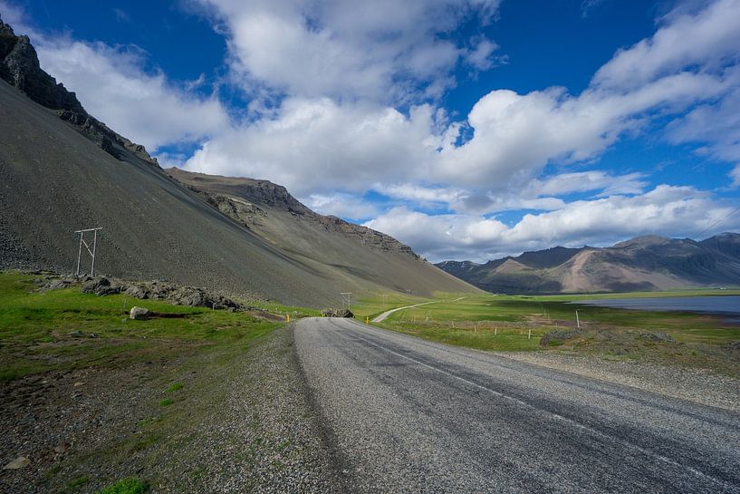 Iceland - Endless twisting road between ocean and volcanic mountain landscape by adventure-photos