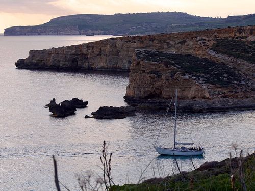 Sailing boat at sunset on comino island