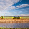The train in the Dutch landscape: Lageveensemolen, Noordwijkerhout. by John Verbruggen