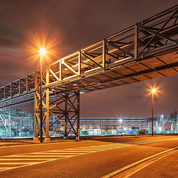Pipeline bridge crossing a road in industrial area at night, Antwerp by Tony Vingerhoets