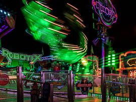 Carousel in motion – a whirl of lights from a fairground ride at night by Mixed media vector arts