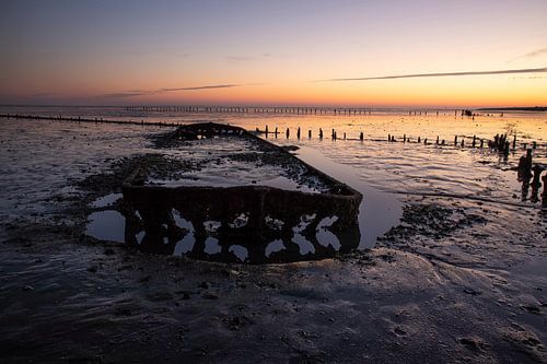 Sunrise with a Shipwreck at the Waddenzee, Netherlands.