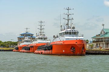Three tugs in a row along the quay in Galveston. by Jaap van den Berg