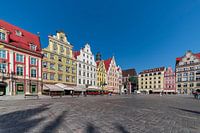 View of Cracow square with medieval brightly coloured houses on a sunny day