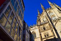 Gothic towers of Burgos cathedral with reflection in glass balcony