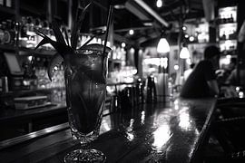 Black and white cocktail glass on wooden bar by Art & Soul Creations