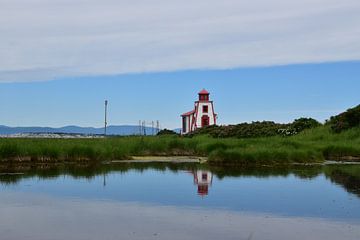 A small lighthouse on the banks of the river by Claude Laprise