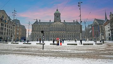 Snow-covered Amsterdam on Dam Square in the Netherlands at sunset by Eye on You