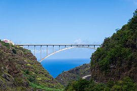 The graceful arch bridge, Puente de Los Tilos, spanning the ocean – La Palma by Natalia Gebauer Studio