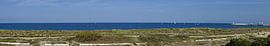 Panoramic view of the beach and dunes with sailing boats and waves in La Turballe, Brittany by Andreas Freund