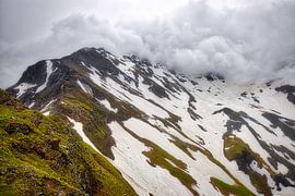 Mountains in the snow and clouds | Alps by Kevin Baarda