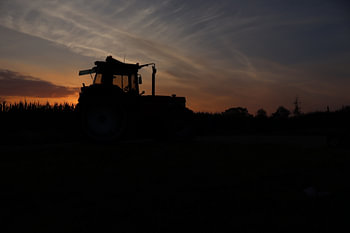 Silhouette of a tractor at sunrise