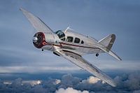 Classic airplane above the clouds