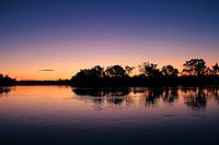 Twilight Reflections Over Calm Waters