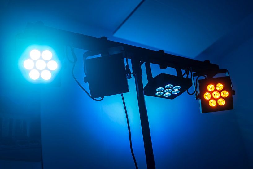 Color tuned led spotlights on a truss in front of a dark blue ba by Maren Winter