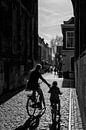 Moeder en kind fietsen onder de Dom van Gerard Til /  Dutchstreetphoto thumbnail