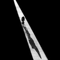 The cyclist out with his shadow