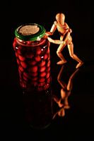 Canned fruit with wooden doll and black background