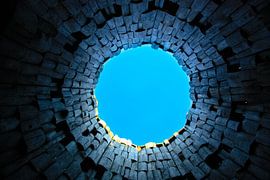 Strange gate and trumpet in the sky. Dark tunnel and blue sky, symbol of death by Michael Semenov