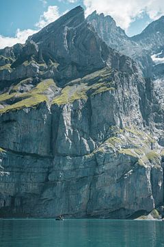 Sharp cliff above blue mountain lake by Joep van de Zandt