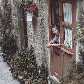 Woman looks out her door by Bert Olivier