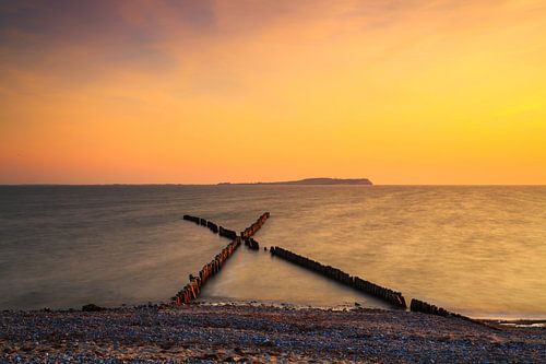 Buhnen at sunset on the beach of Rügen
