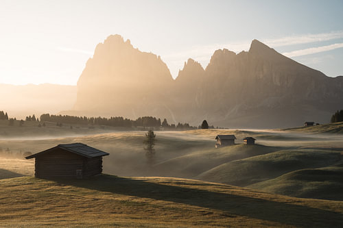 Sunrise over the Alpe di Siusi (Seiser Alm) in the morning mist