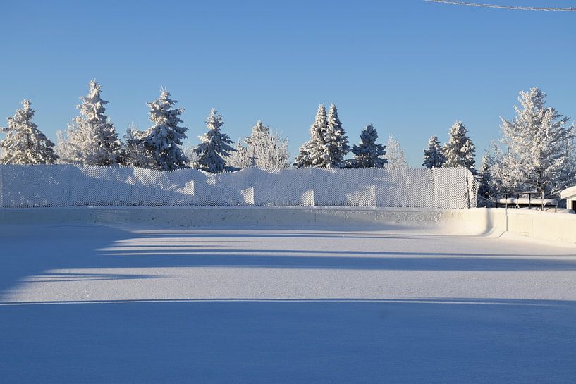 The village's ice rink in winter by Claude Laprise