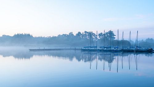 Sailboats at jetty Leekstermeer before sunrise