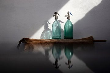 Still life of antique glass spray bottles