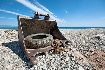 bucket of an excavator on the beach