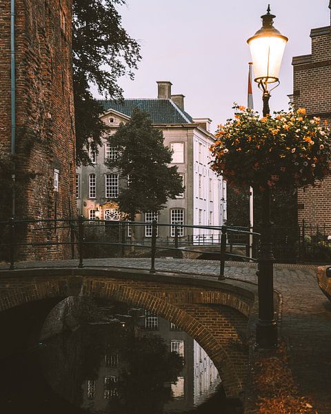 Bridge over a canal in the wall houses of Amersfoort by Michiel Dros