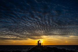 The lighthouse and the setting sun in perfect harmony by Gerry van Roosmalen