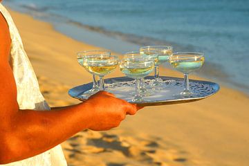 Champagne is served on the beach. by Matthias Stolt