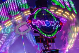 The centre of rotation – a carousel bathed in the vibrant lights of the fairground by Mixed media vector arts