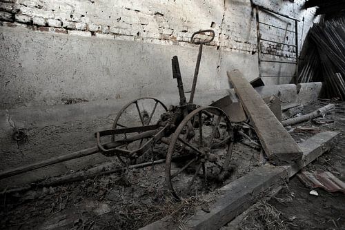 A farm tool in a barn.
