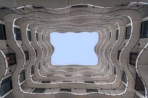 Looking up at the different lines and shapes of an apartment complex