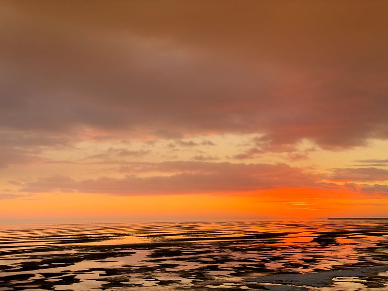 Ondergaande zon op de Wadden van Jan Huneman