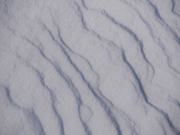 Sneeuwoppervlak met structuren door stuifsneeuw van mekke