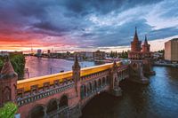 Berlin Oberbaumbrücke at sunset with subway