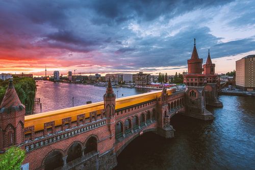 Berlin Oberbaumbrücke at sunset with subway