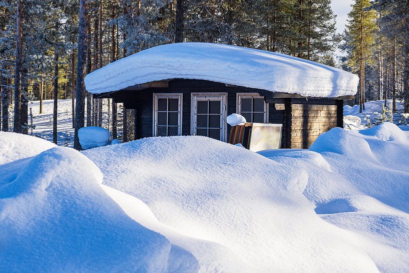 Landschaft mit Schnee und Holzhütte im Winter in Kuusamo, Finnl von Rico Ködder