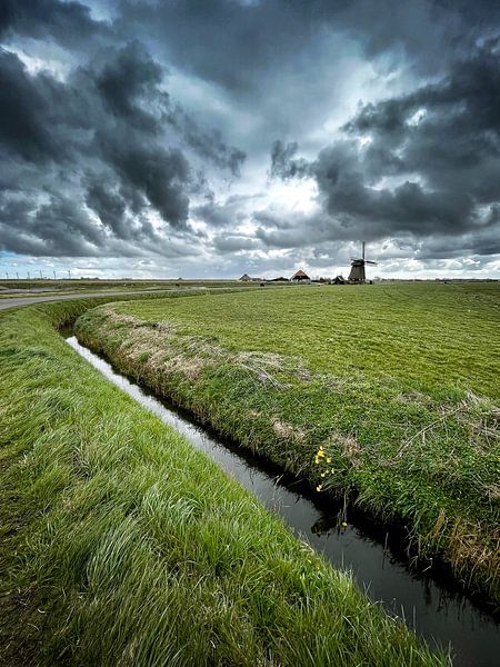 Ditch, mill and threatening sky by Peter van der Waard
