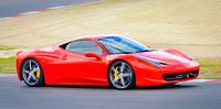 Red Ferrari 458 Italia sports car driving at high speed